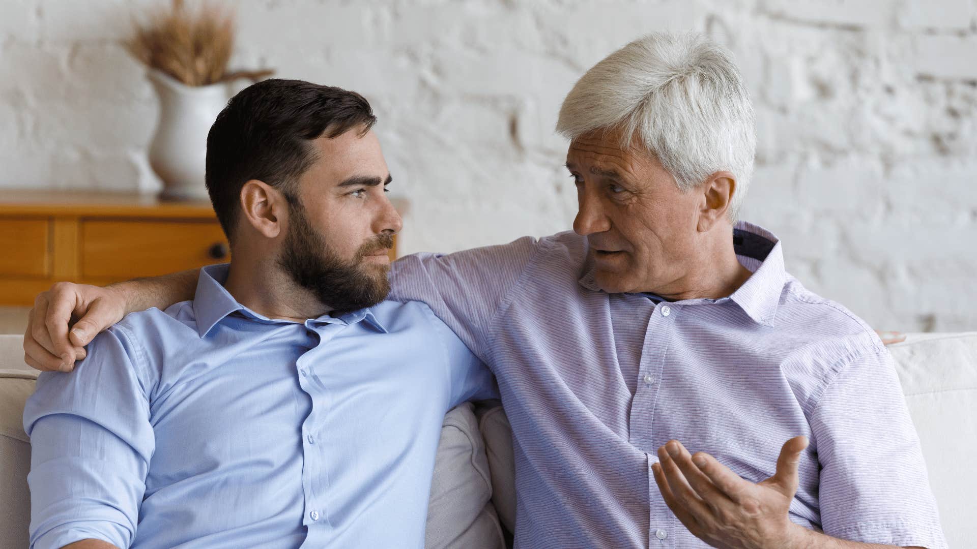 older man explaining something to younger man