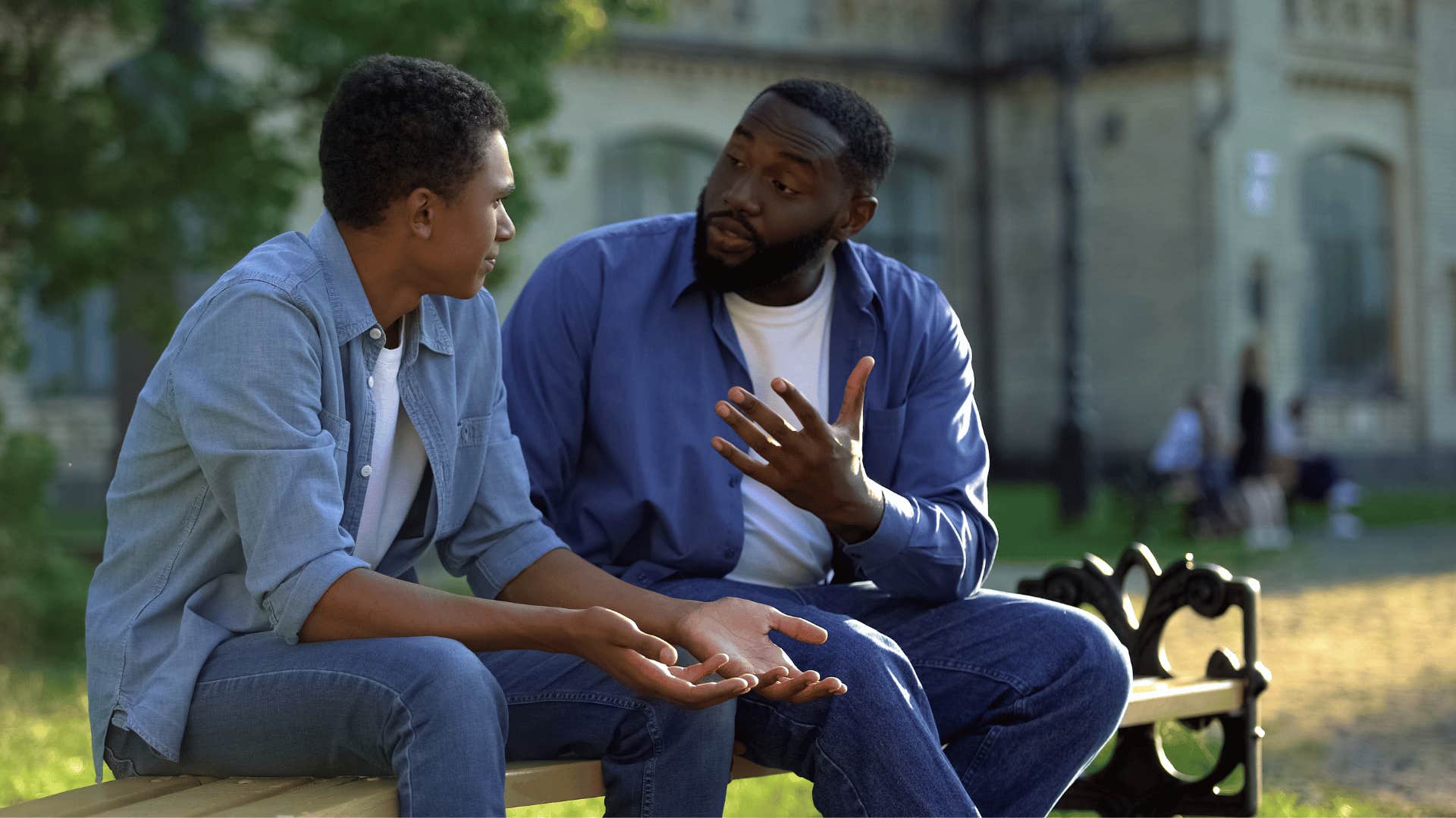 father and son talking on bench