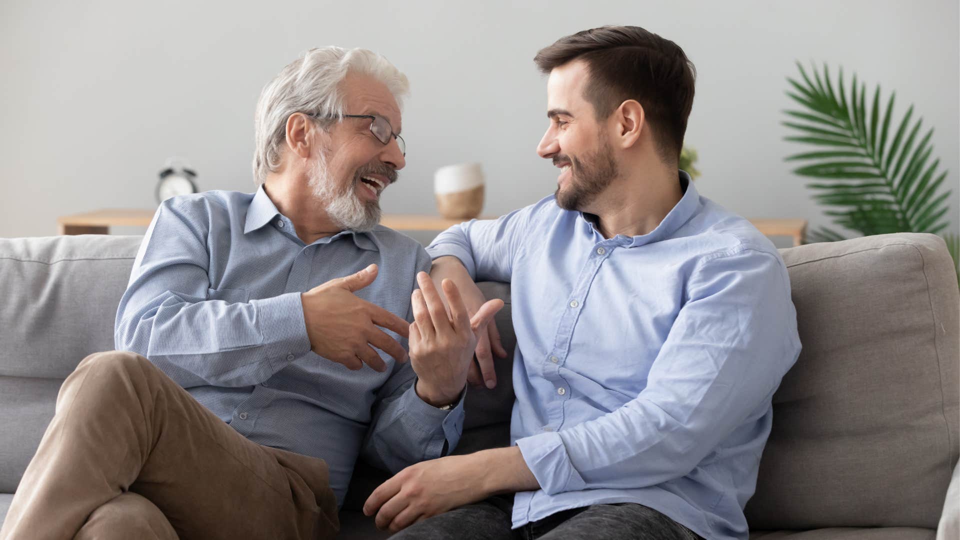 father and son sitting on a couch