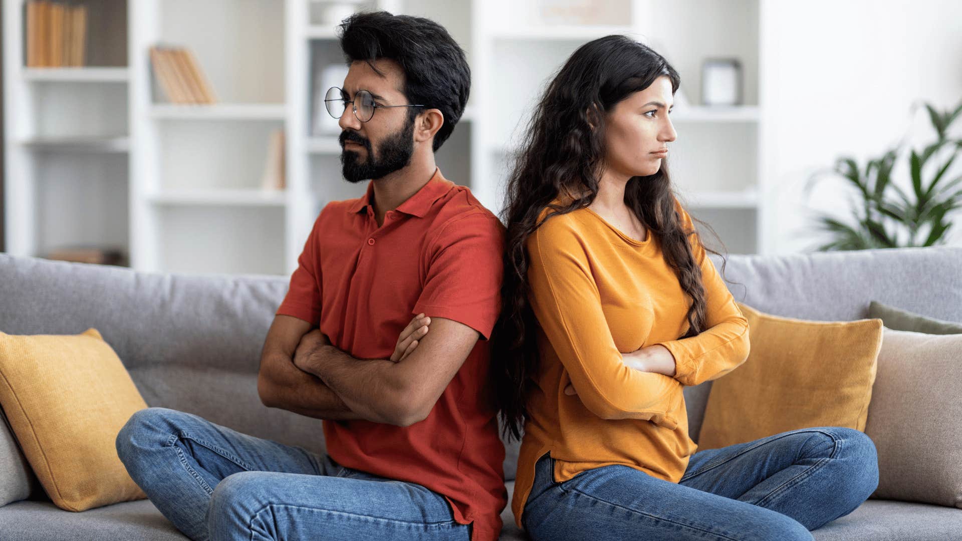 couple sitting with their backs to each other