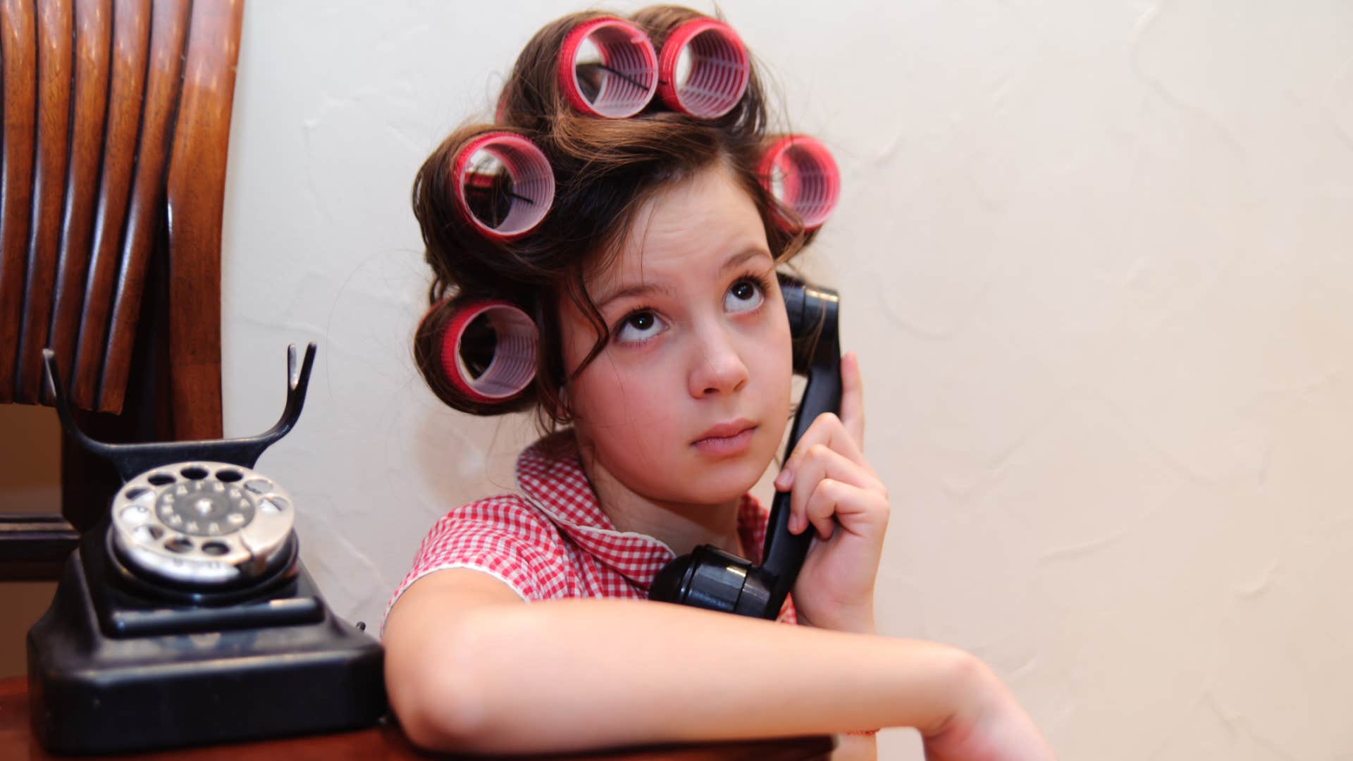 girl talking on a landline phone