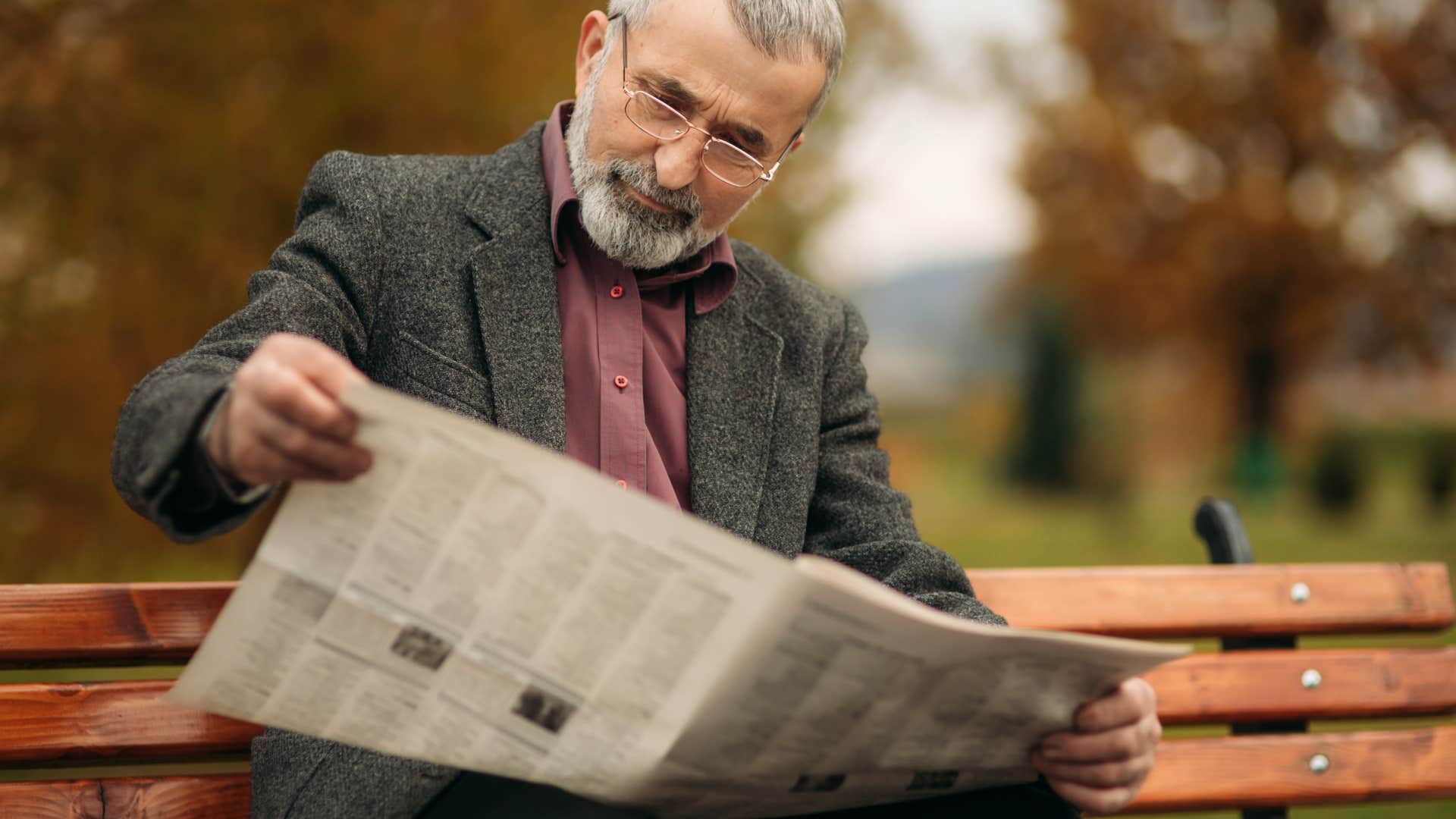 boomer man reading a print newspaper