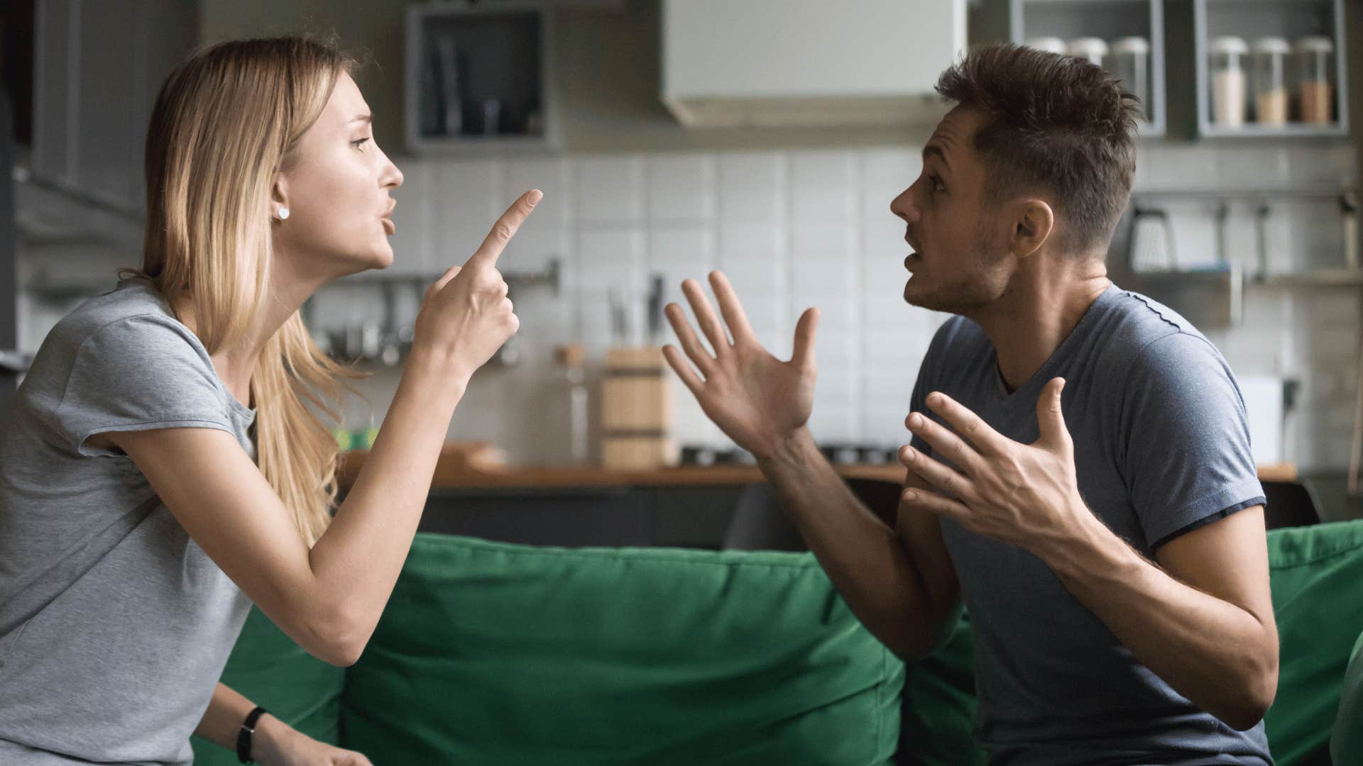 woman yelling at man on couch