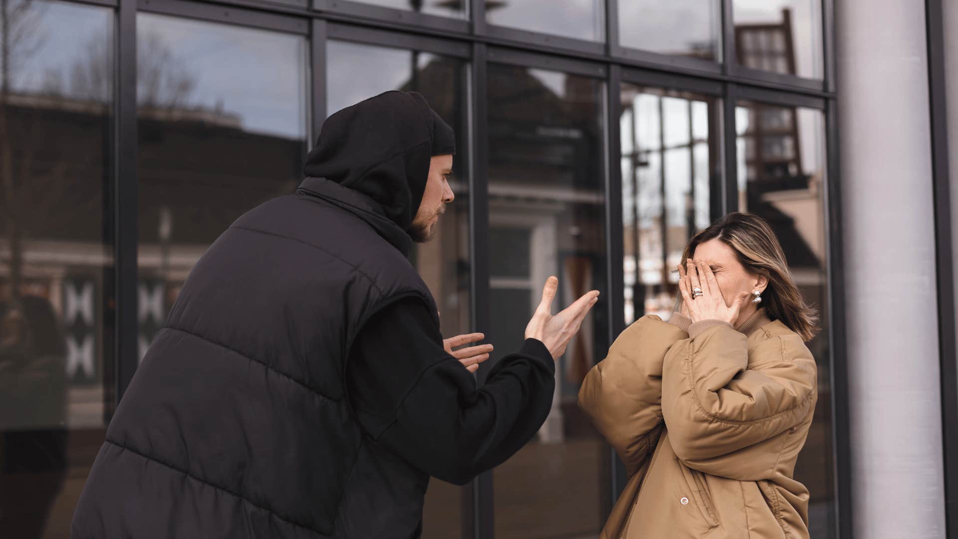 man yelling at woman outside