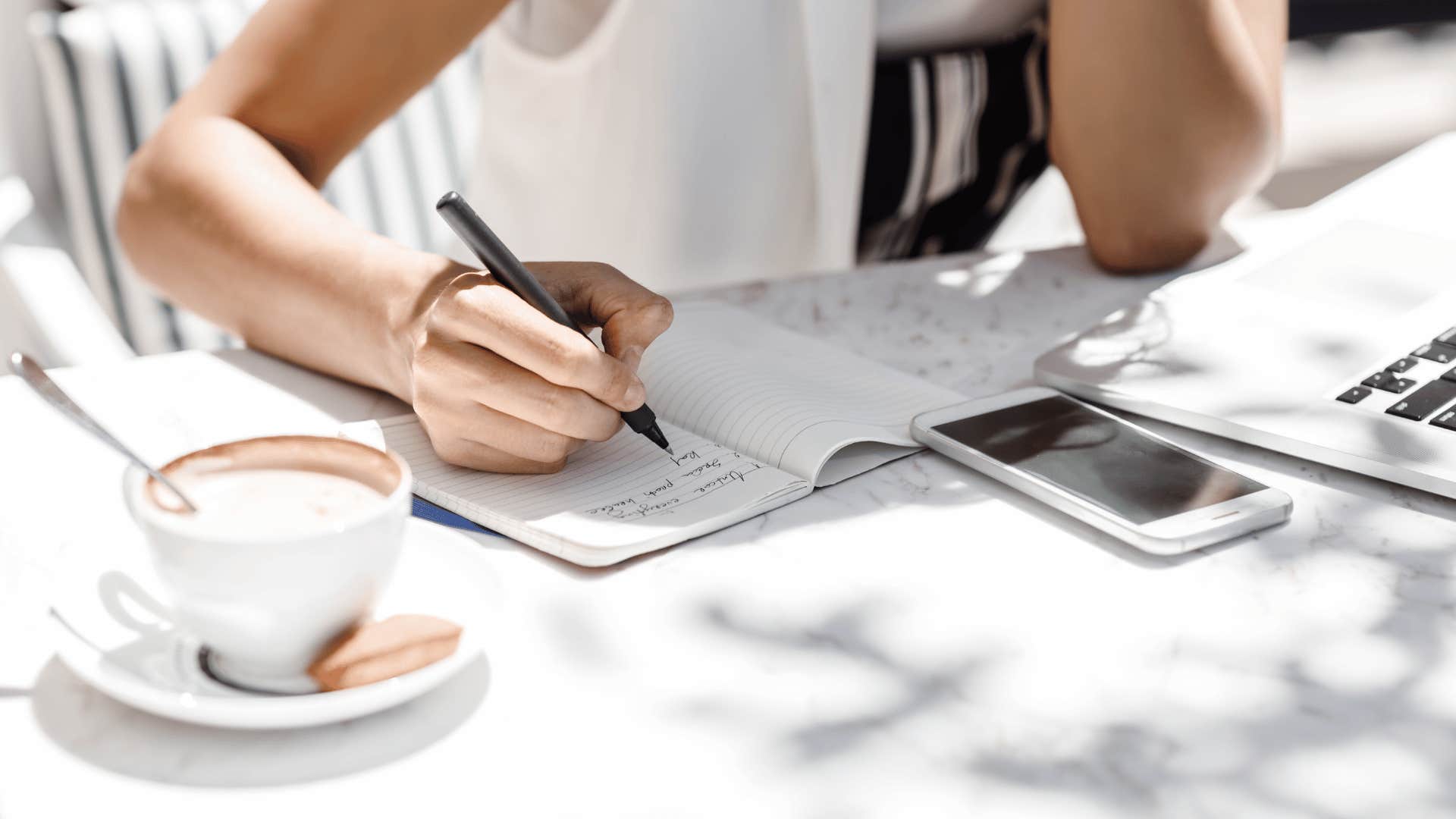 woman writing outside