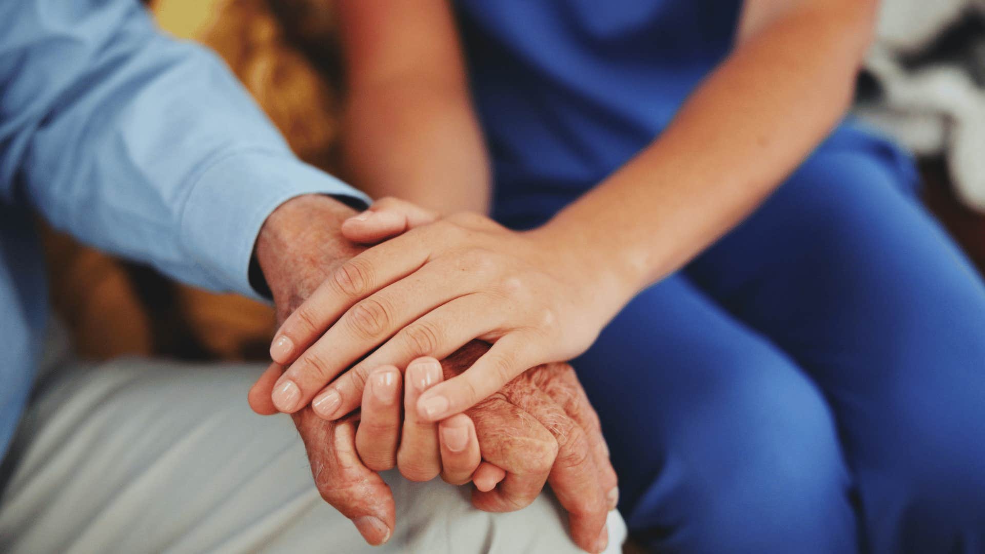 younger person holding other persons hand