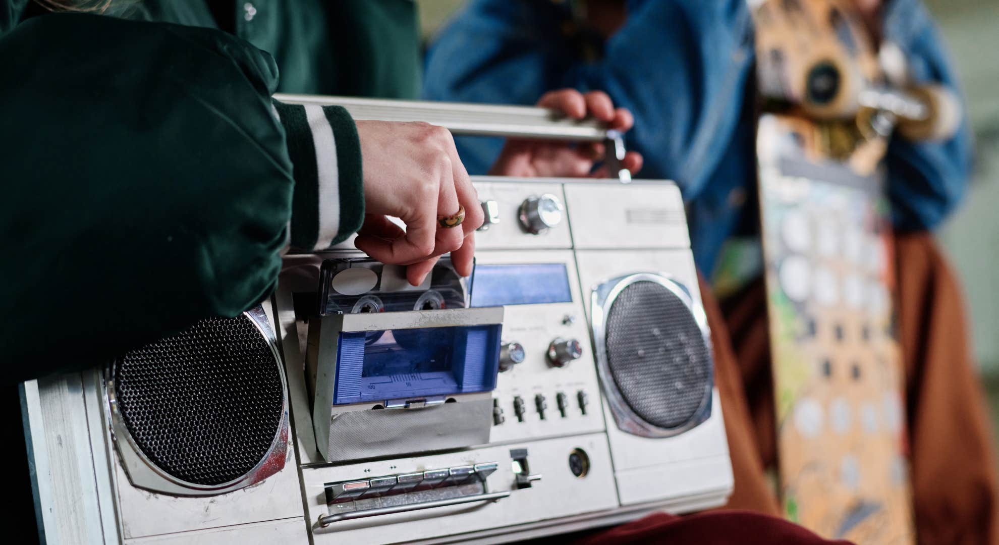 putting cassette tape in a boom box