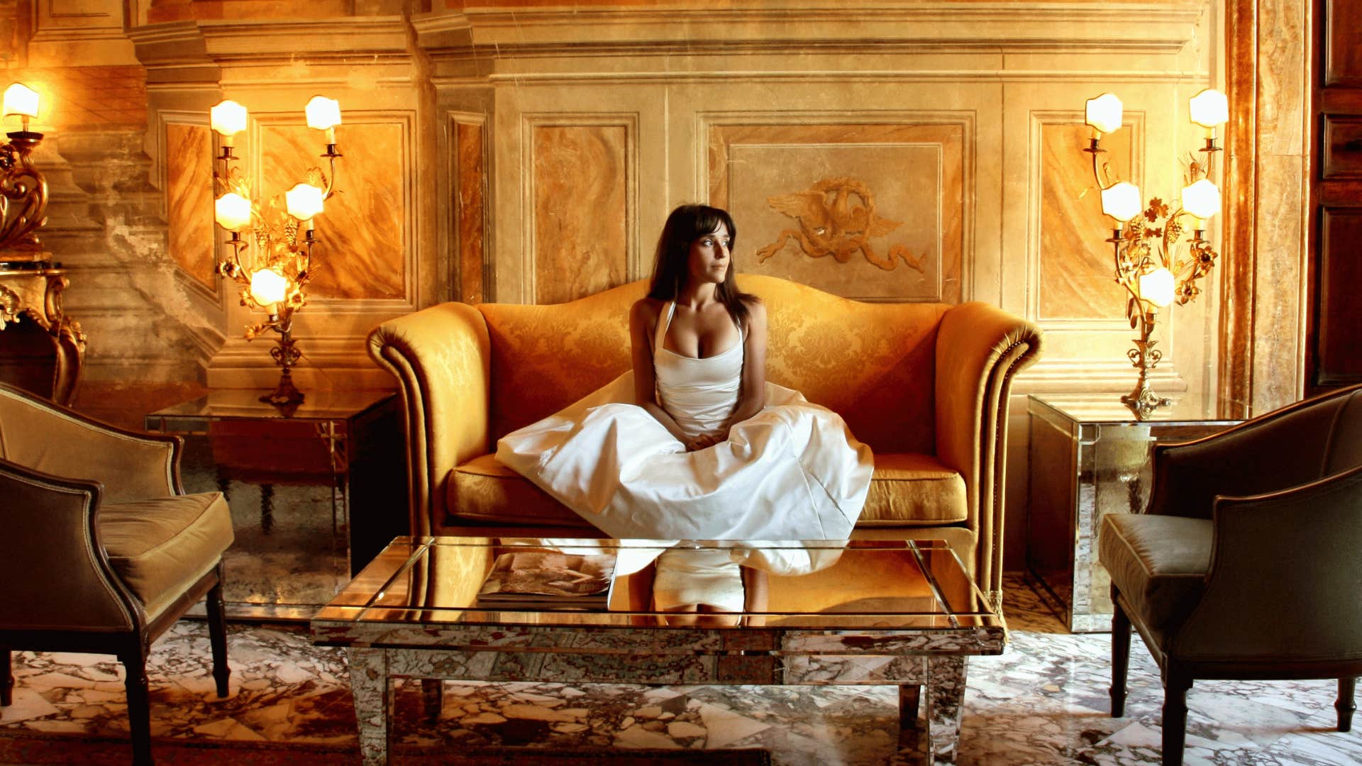 woman sitting in room full of luxe furnishings