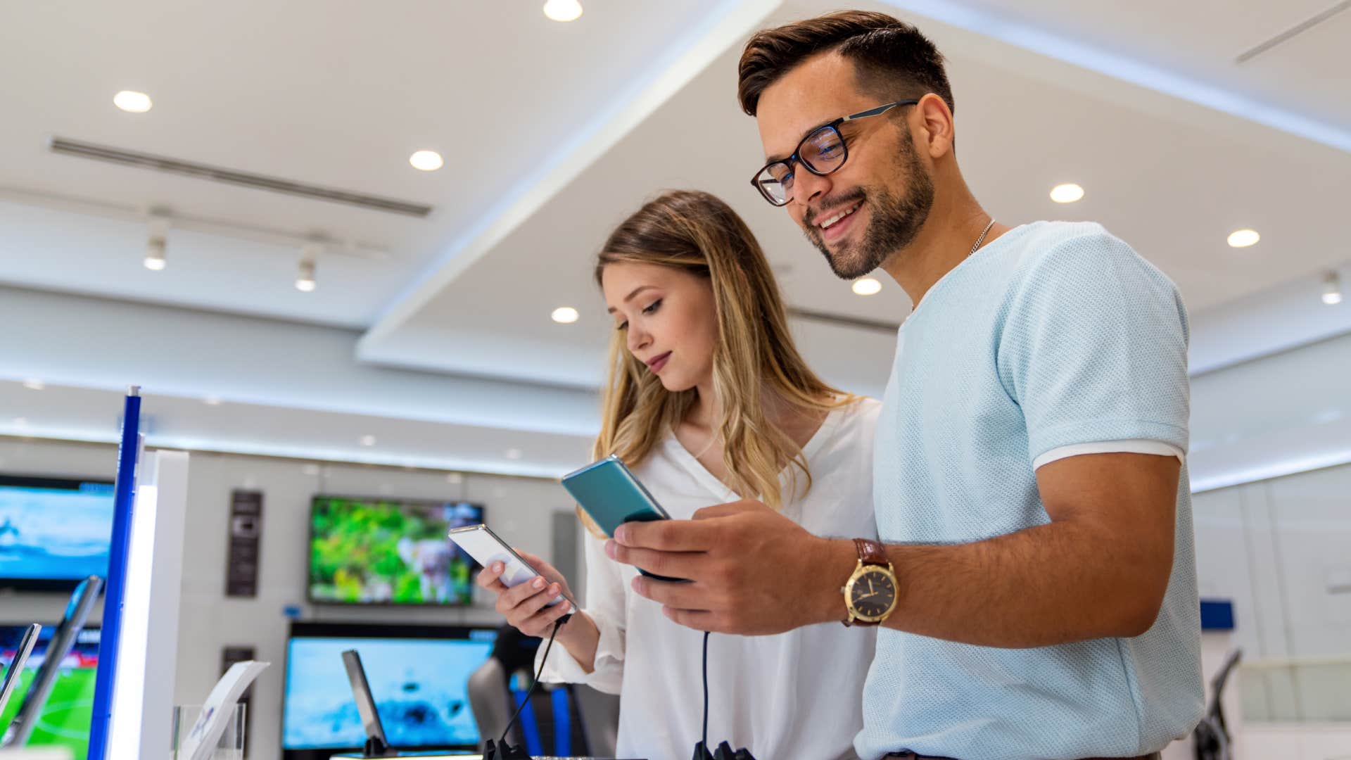 young people buying a new smartphone in mobile shop.