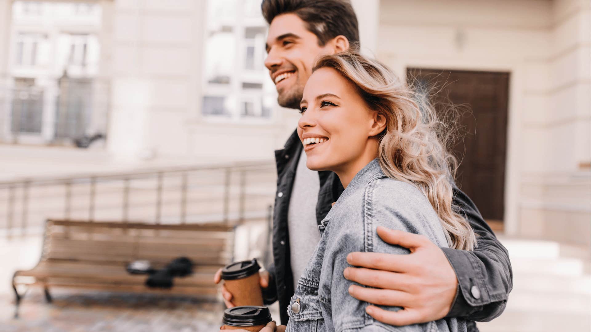 happy couple walking with coffee