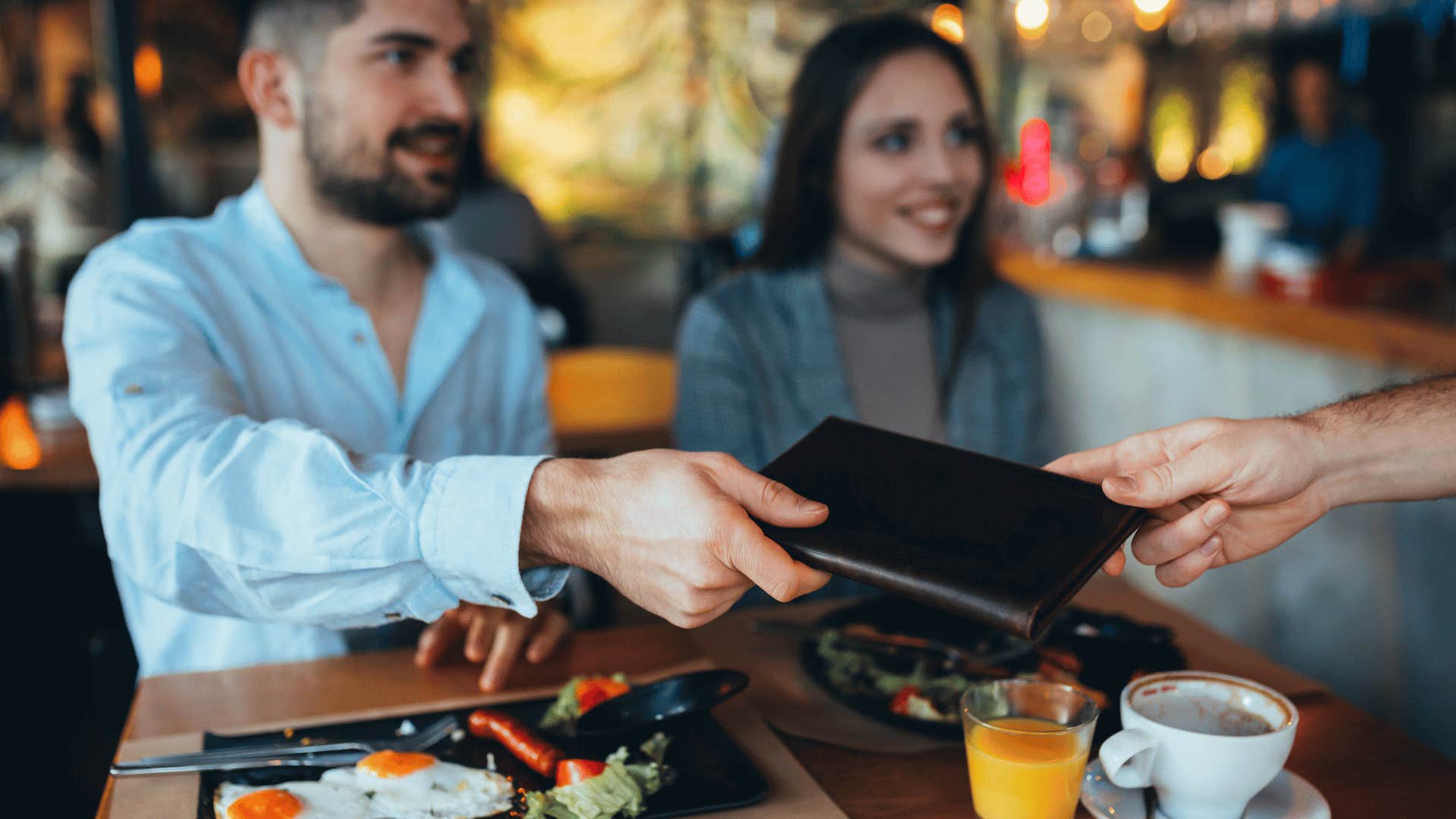 man paying on a date