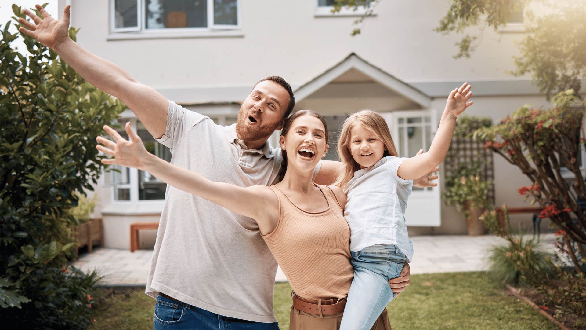 happy family in front of house