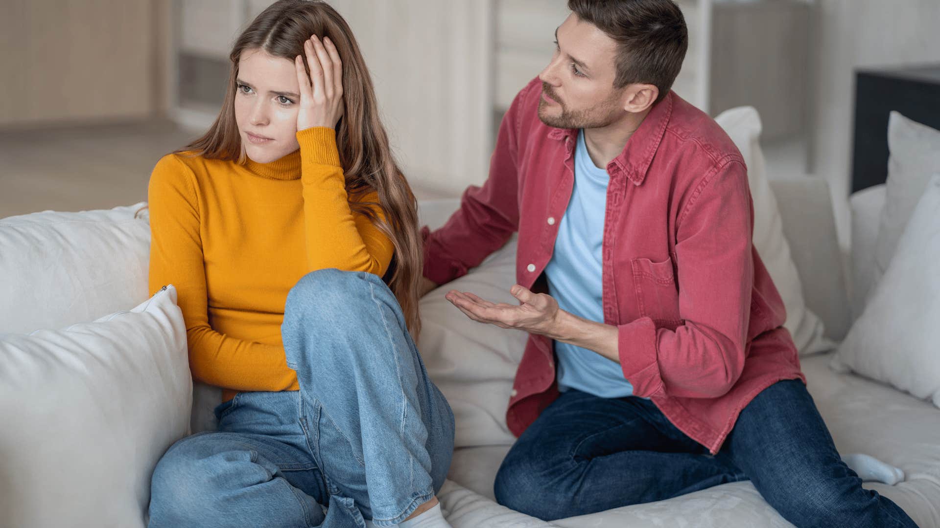 woman ignoring partner trying to talk to her