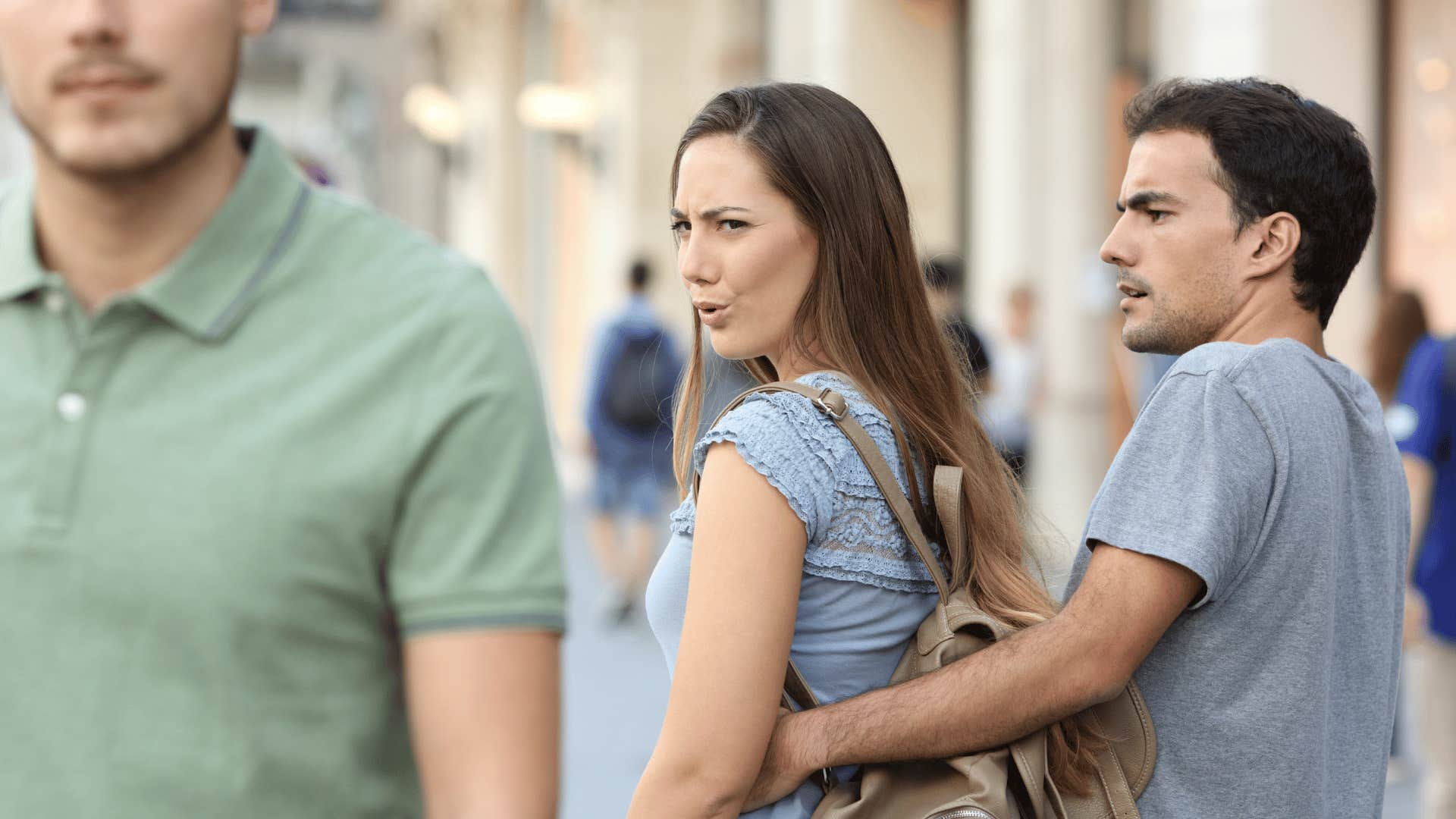 woman checking out another man with boyfriend