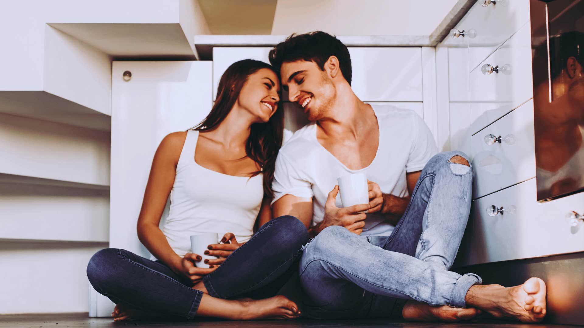 husband and wife sitting together by stairs