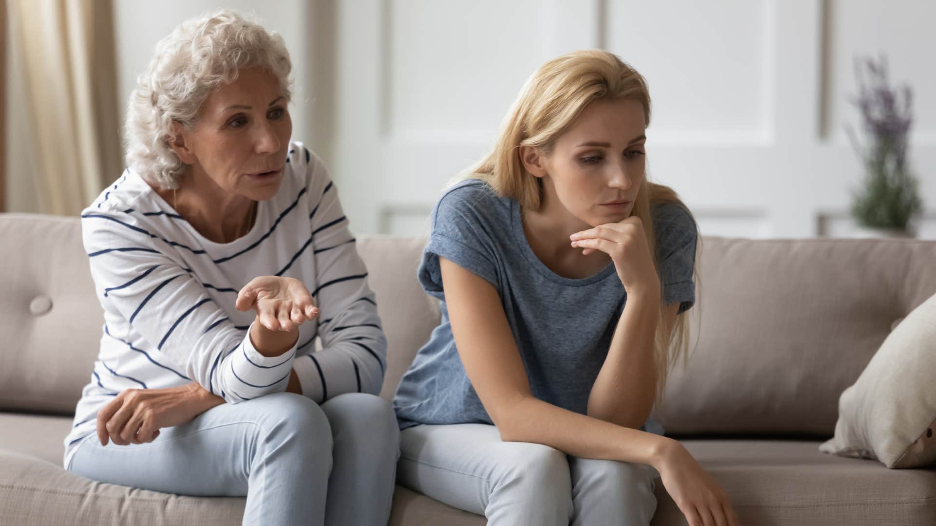 unhappy woman having argument with mom on couch