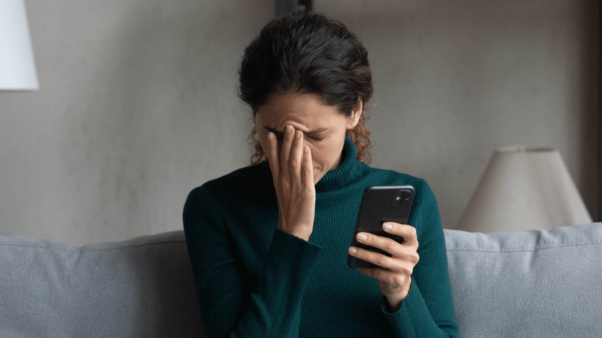 woman stressed while holding phone