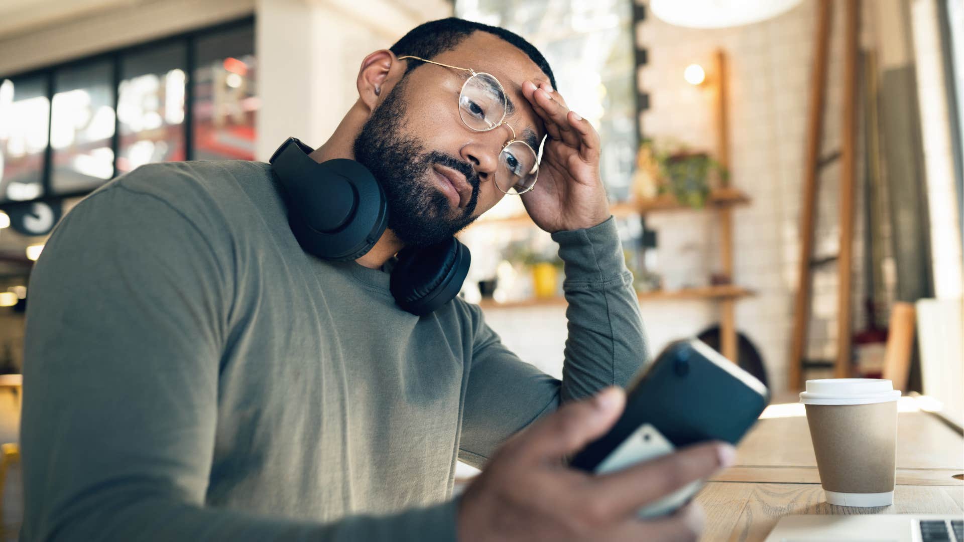 Annoyed man checking his phone in public.