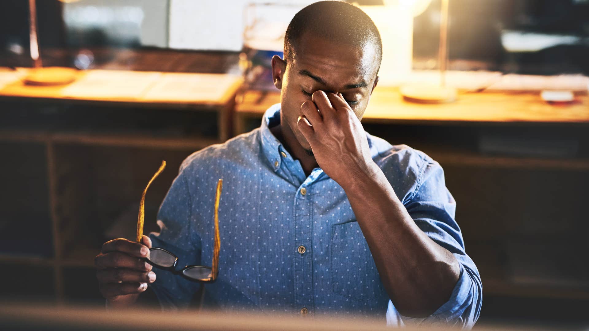 Stressed man working late in his office.