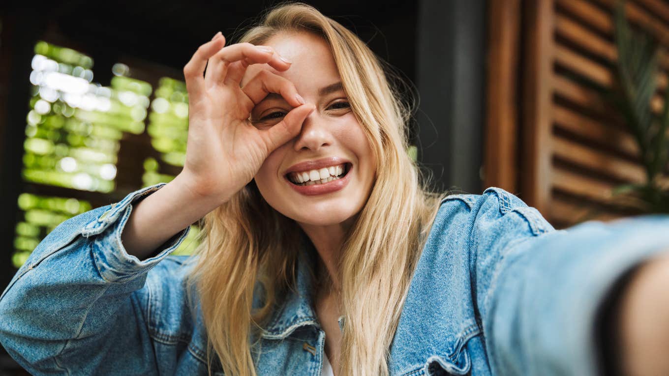  excited happy young woman posing outdoors in cafe take a selfie 