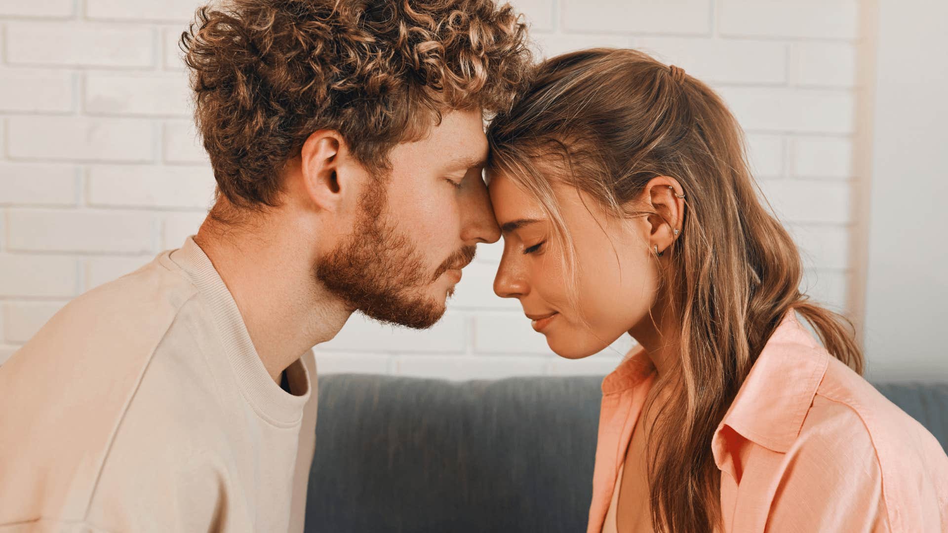 man and woman putting their heads together lovingly