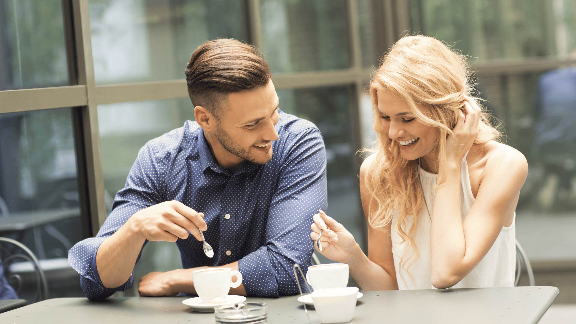 woman tucking hair behind ear on date