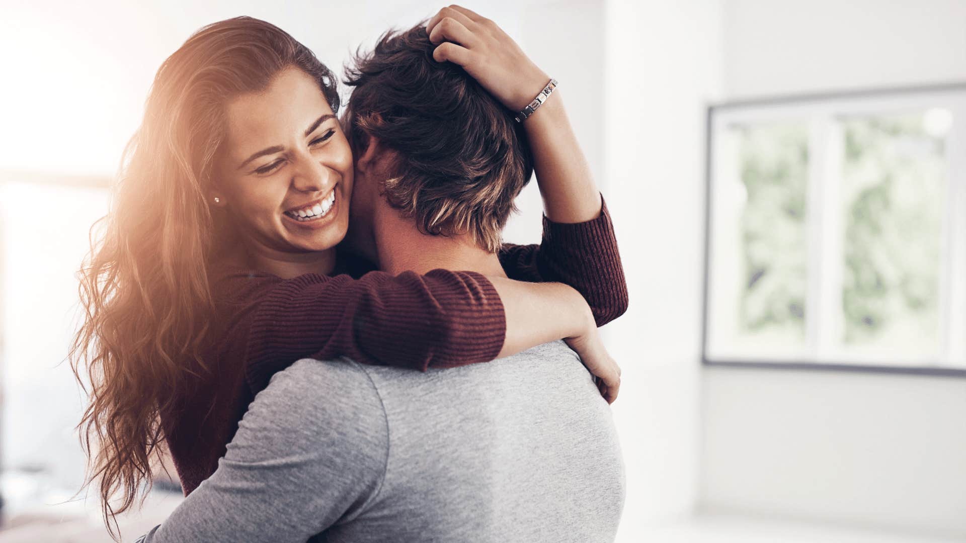 man hugging woman