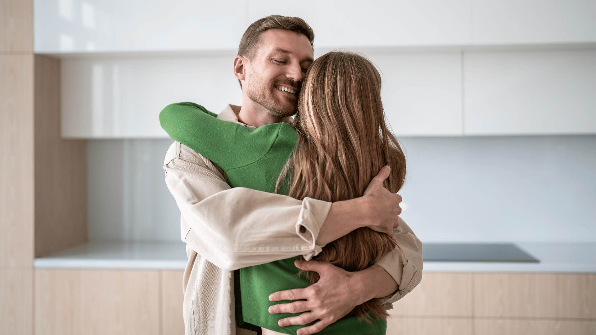 man hugging woman