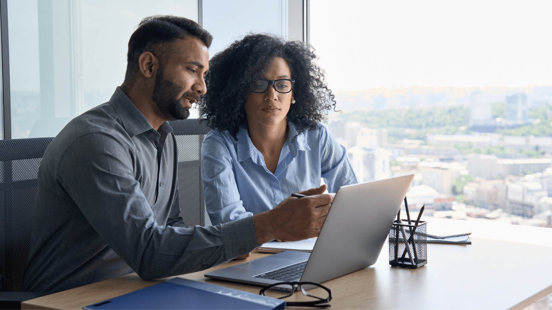 man and woman looking at laptop together