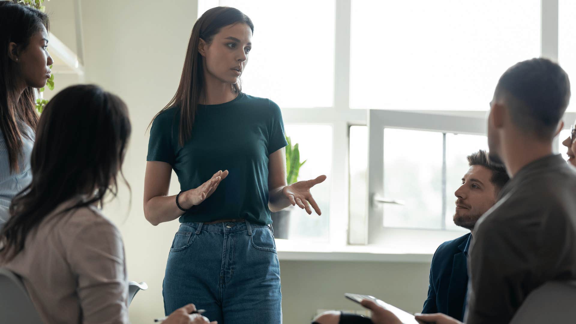 woman explaining something to group of people