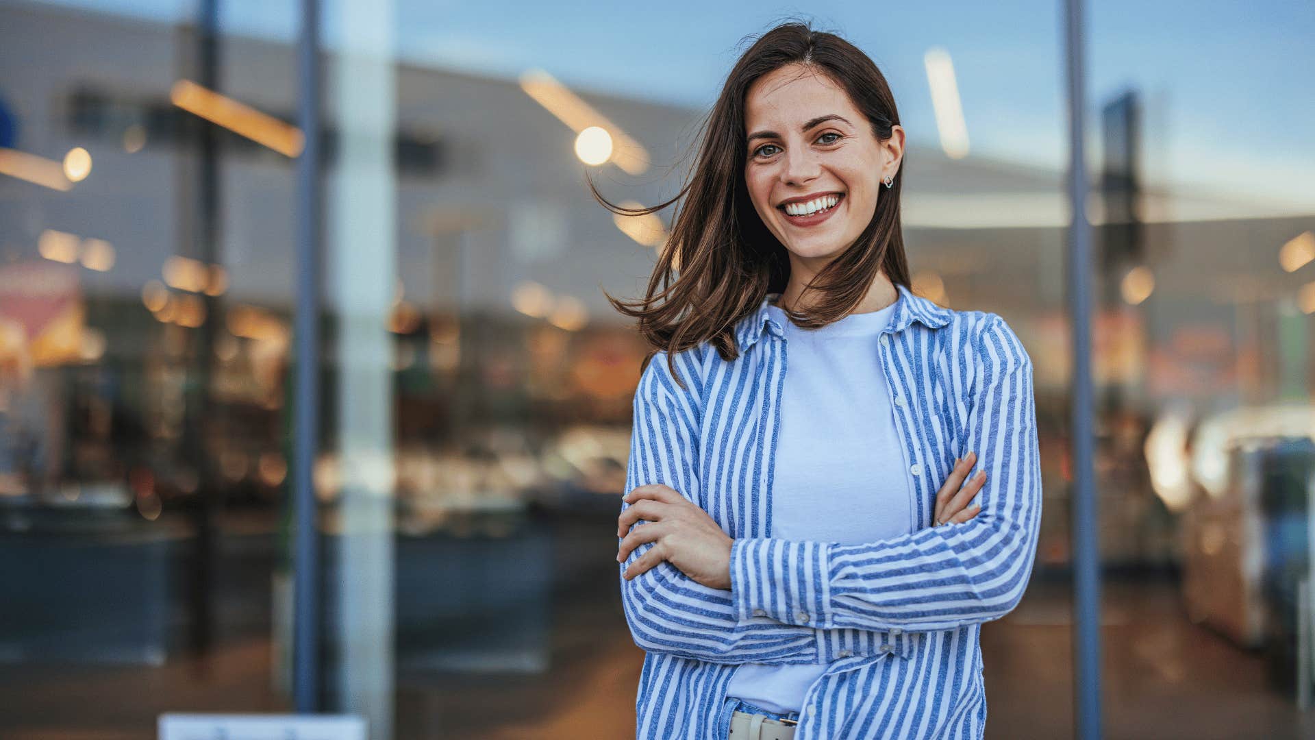 woman crossing arms while smiling