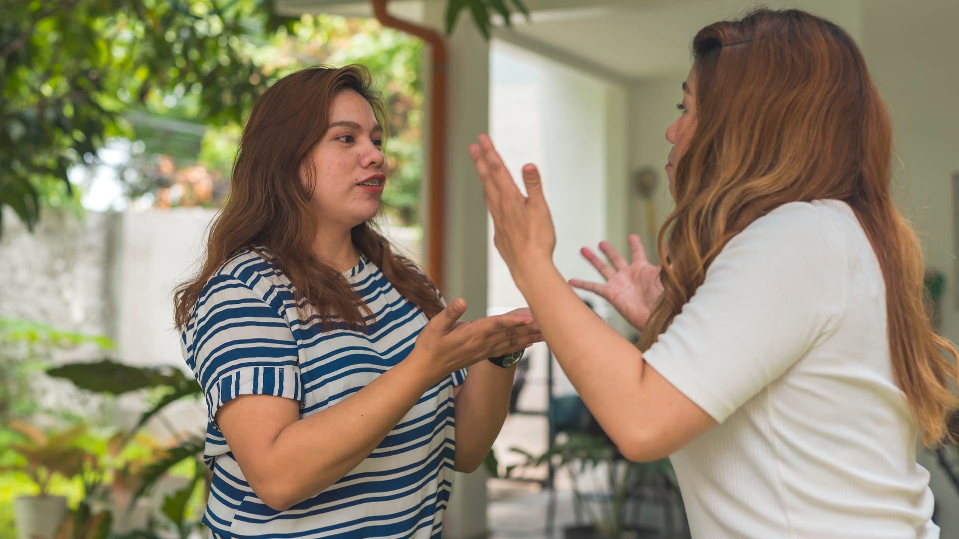 Two women arguing outside. 