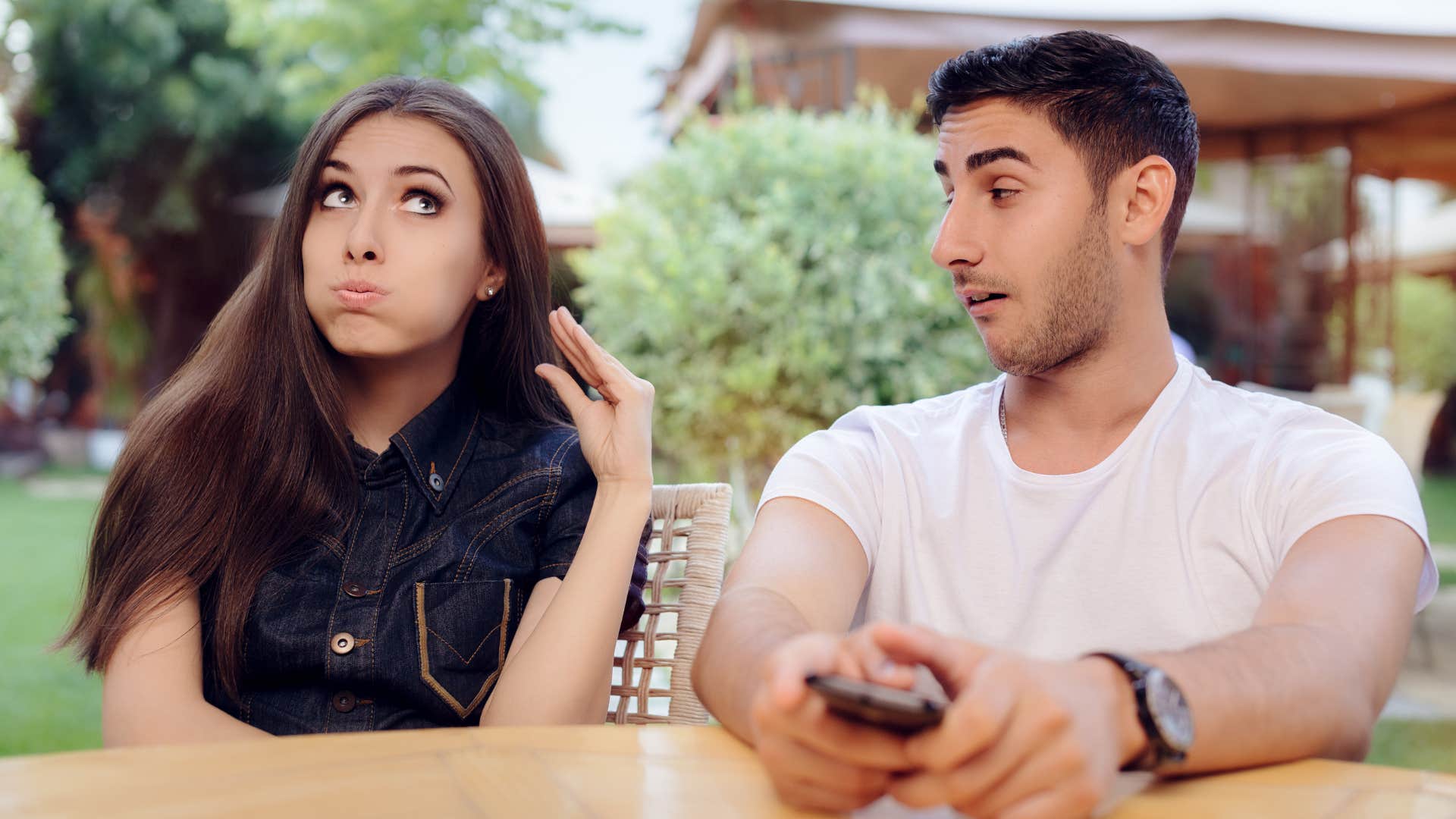 Woman rolling her eyes sitting next to her partner.