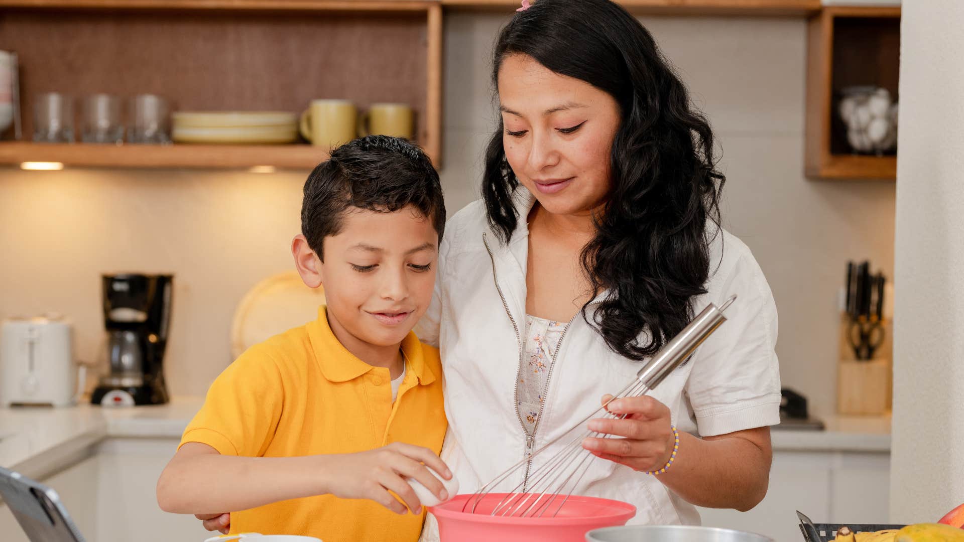 woman cooking with her young son