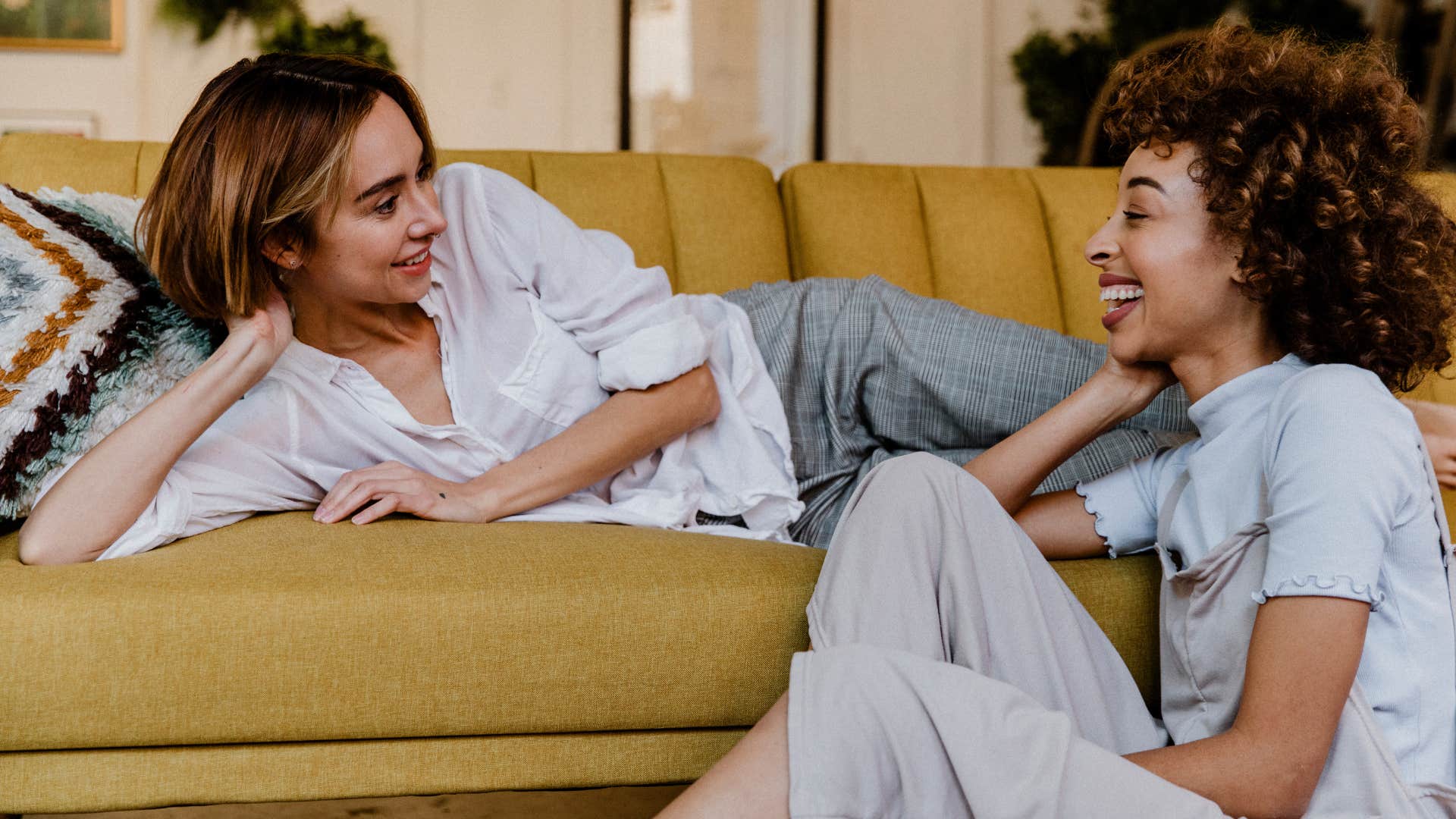 two smiling women talking to each other about family