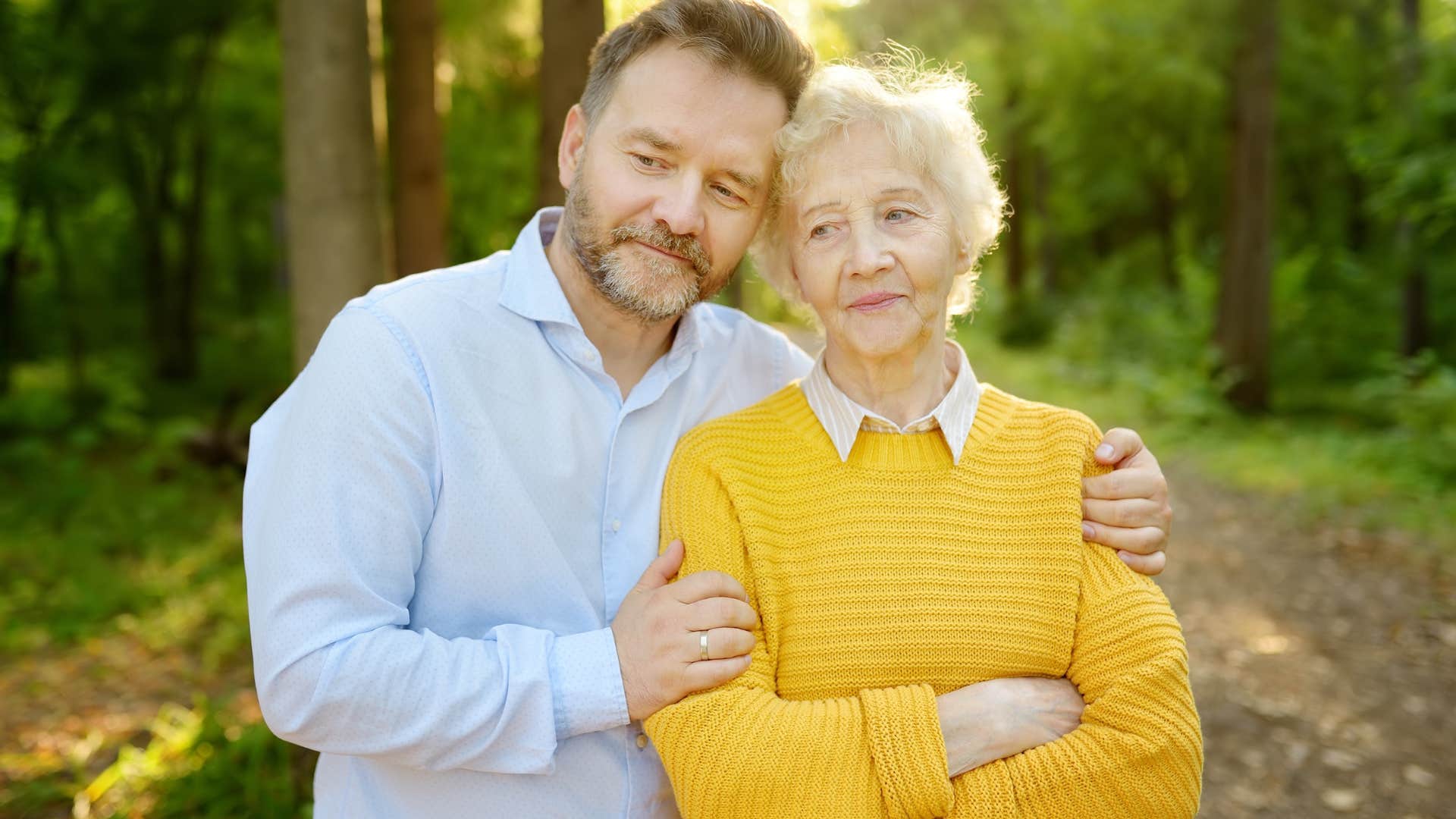 man hugging his older mother