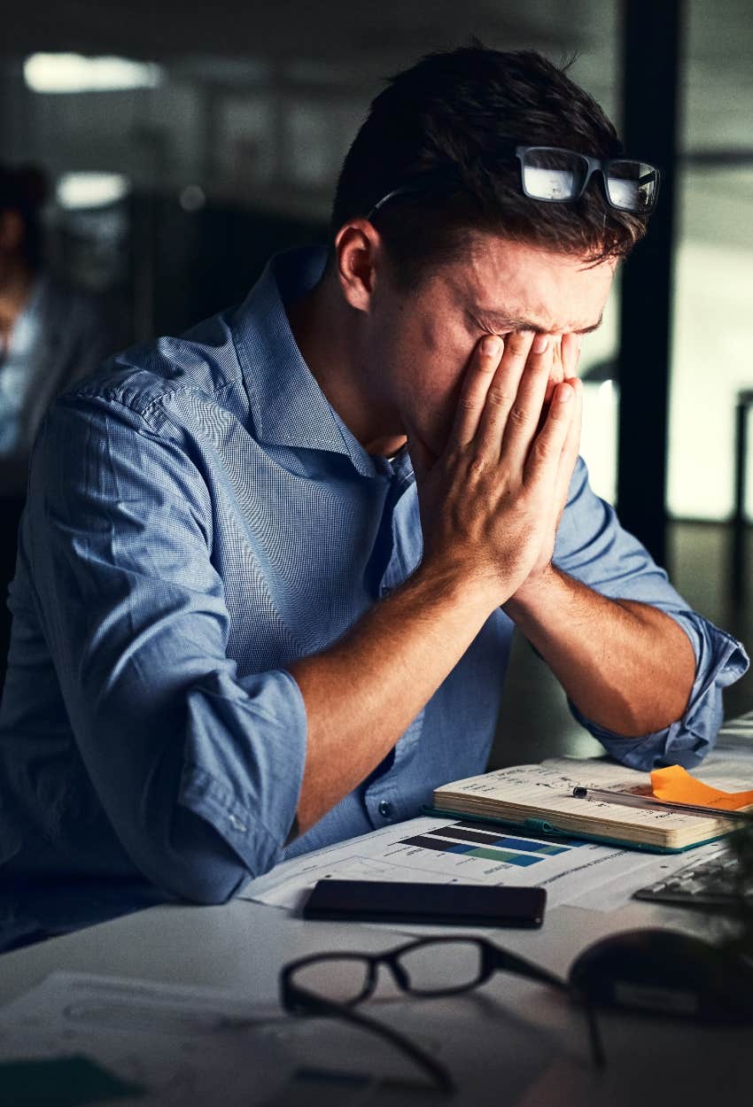 Sleep deprived man struggling to work