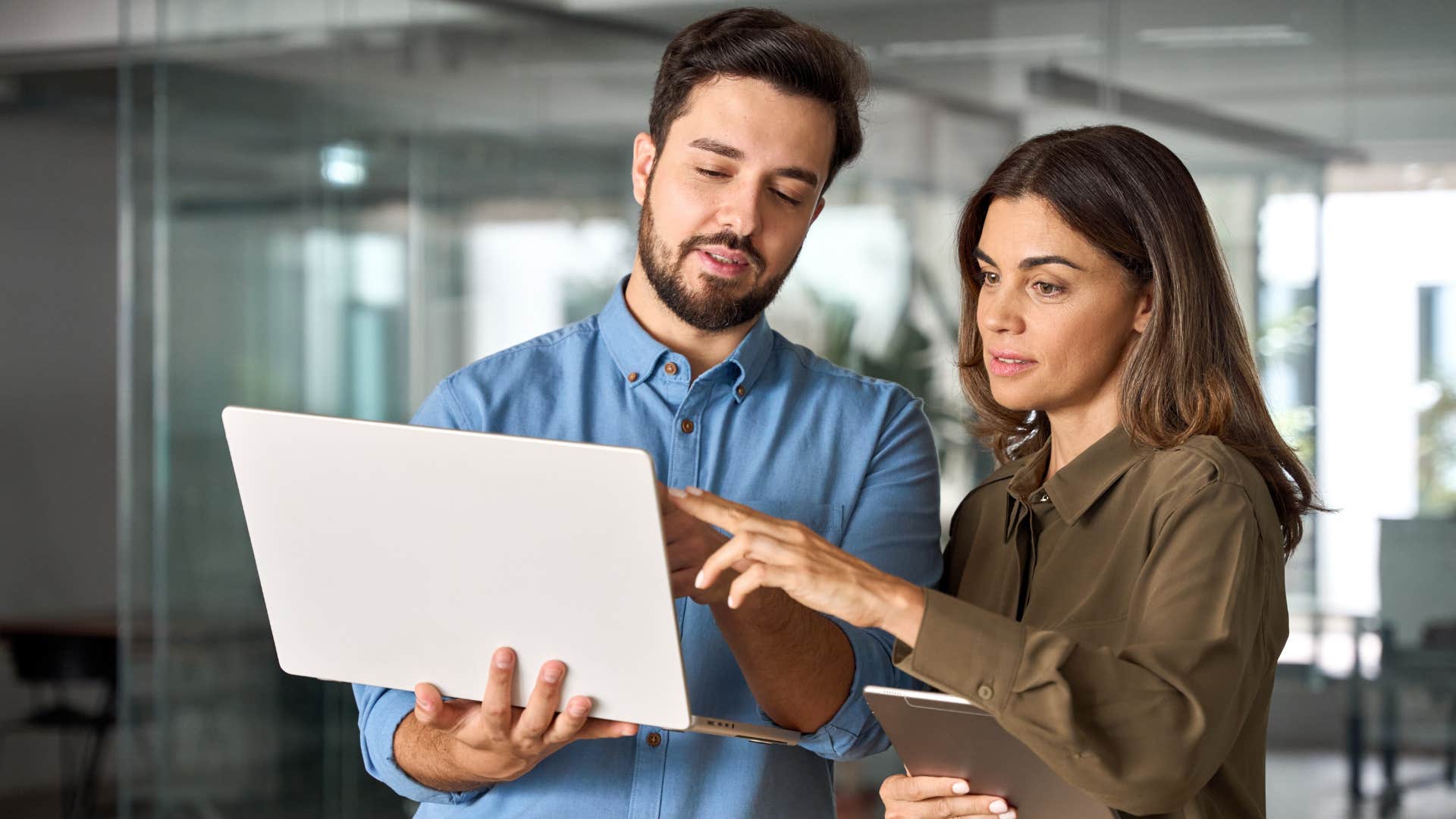 Co-workers looking at a laptop together.