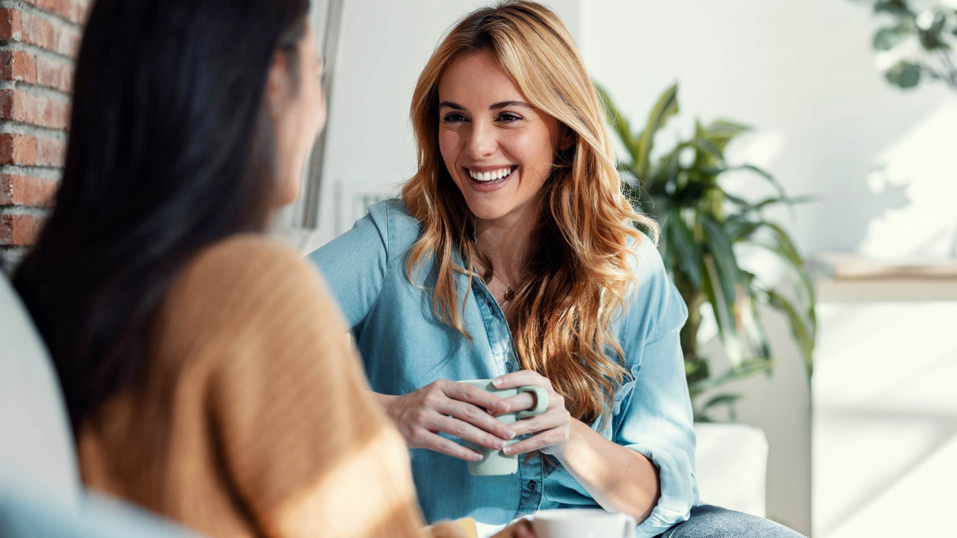 Woman smiling and talking to her friend.