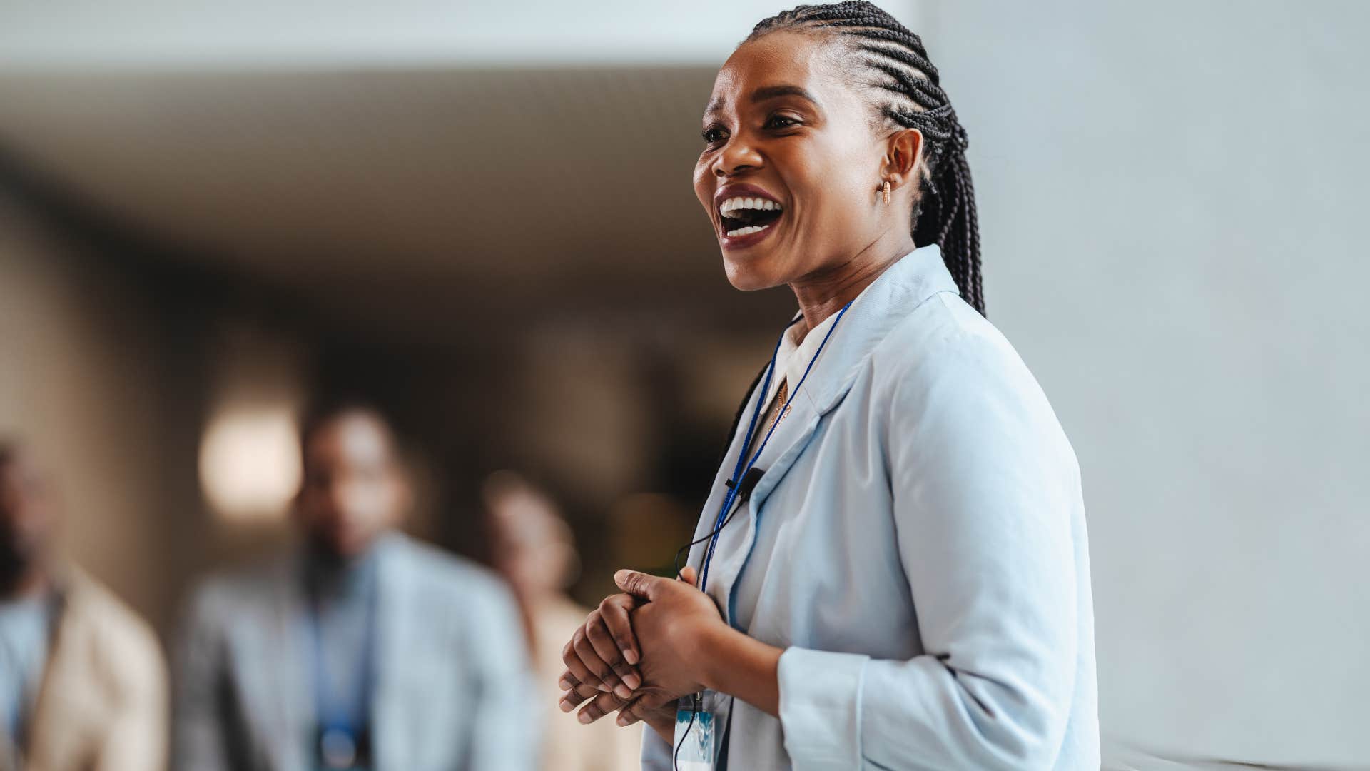 Professional woman smiling and giving a speech.