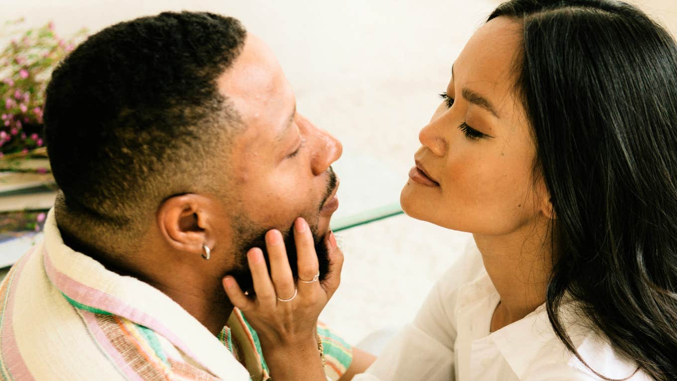 Woman touching mans face, whose love language is touch.