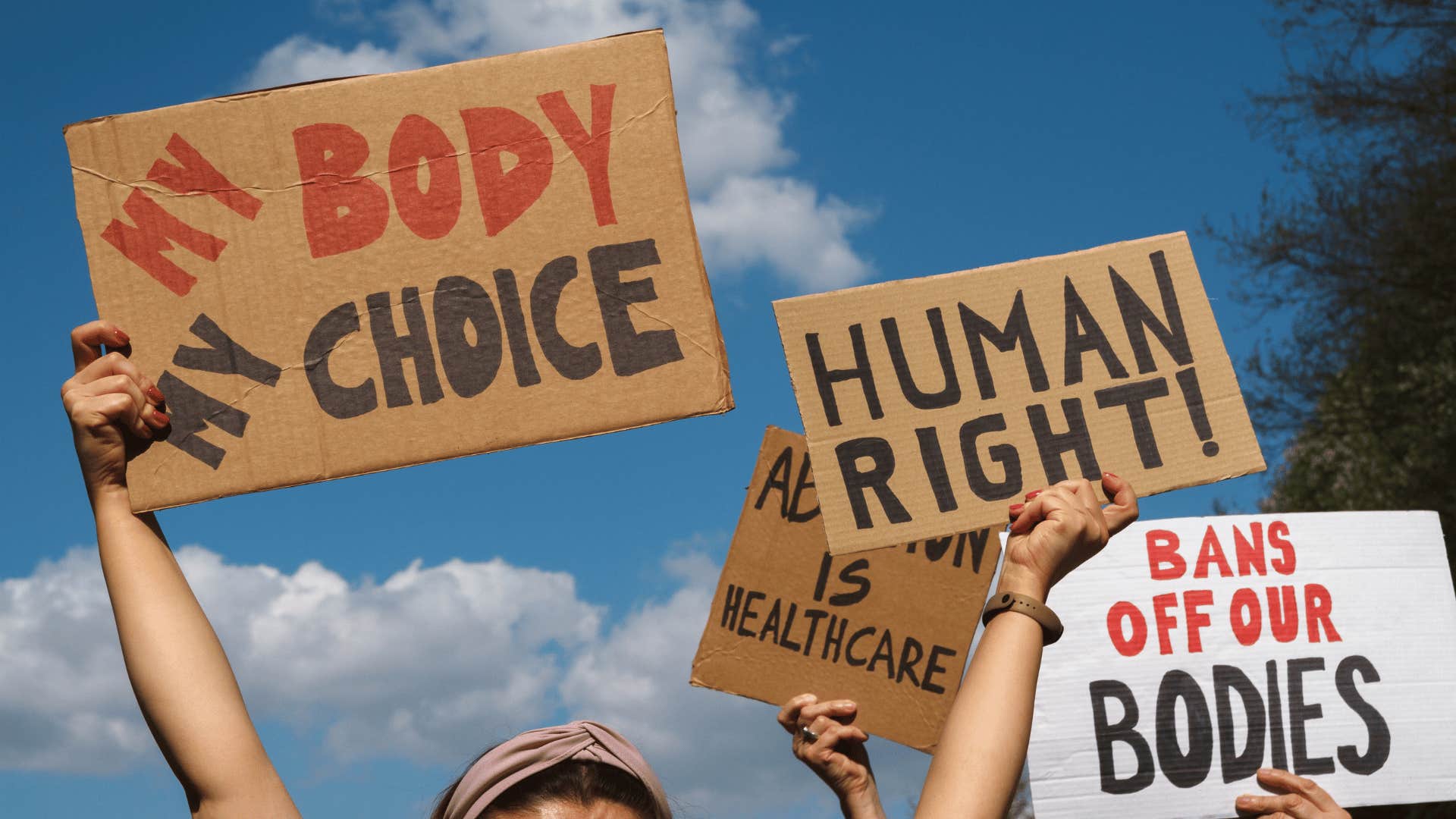 women holding up my body my choice signs