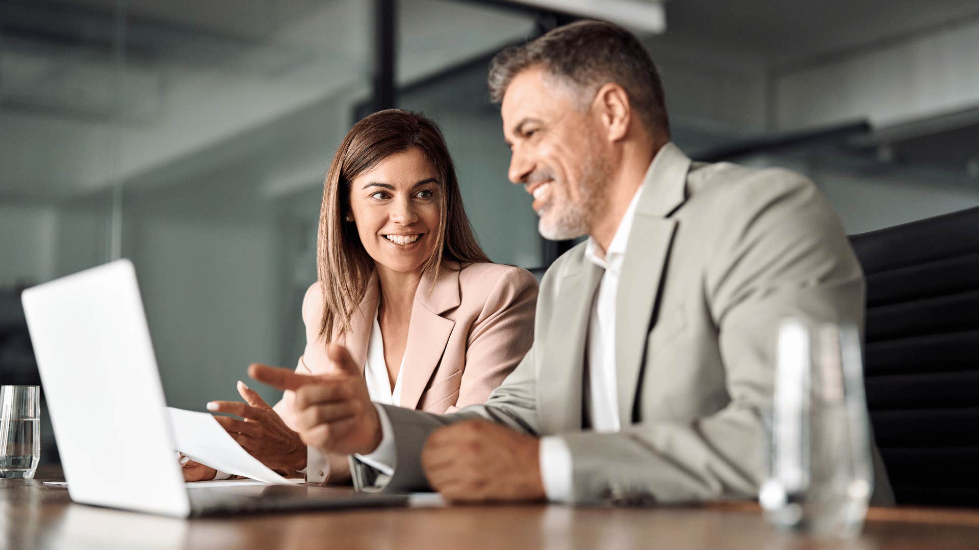 man and woman looking at laptop