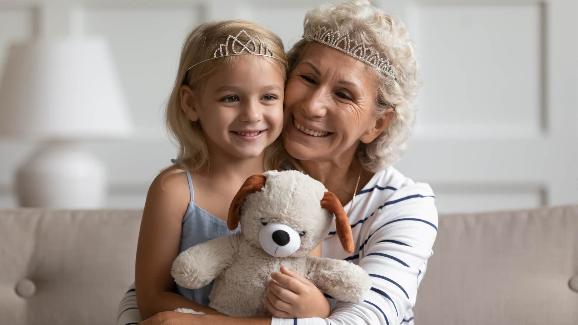 Woman smiling and hugging her young granddaughter