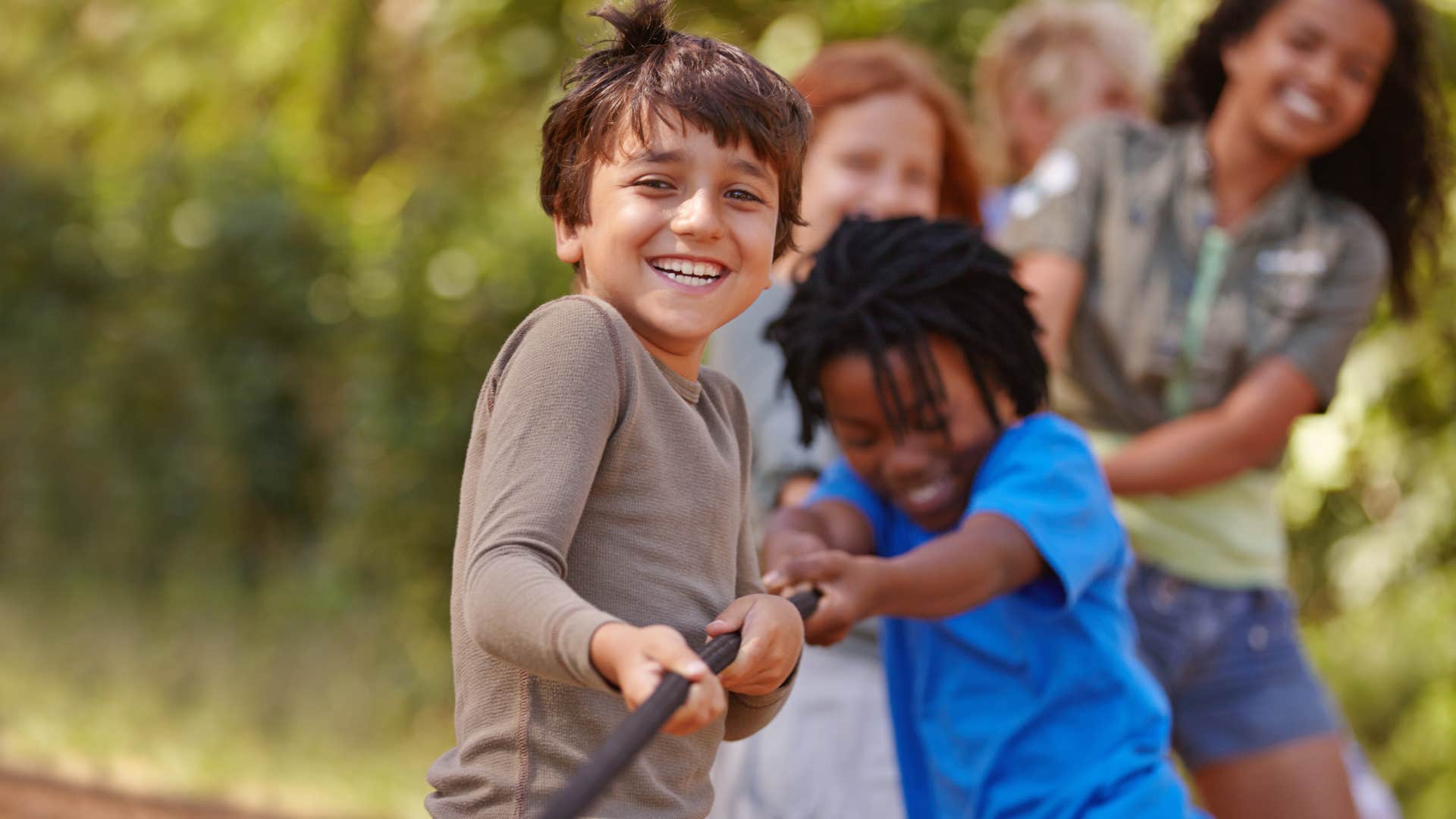 Little kids pulling on a rope at summer camp