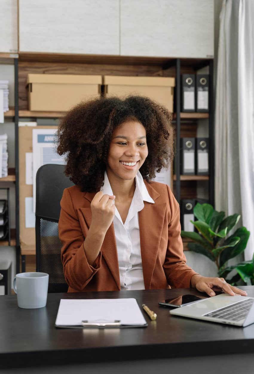 successful woman smiling with facially expressive high-status gesture