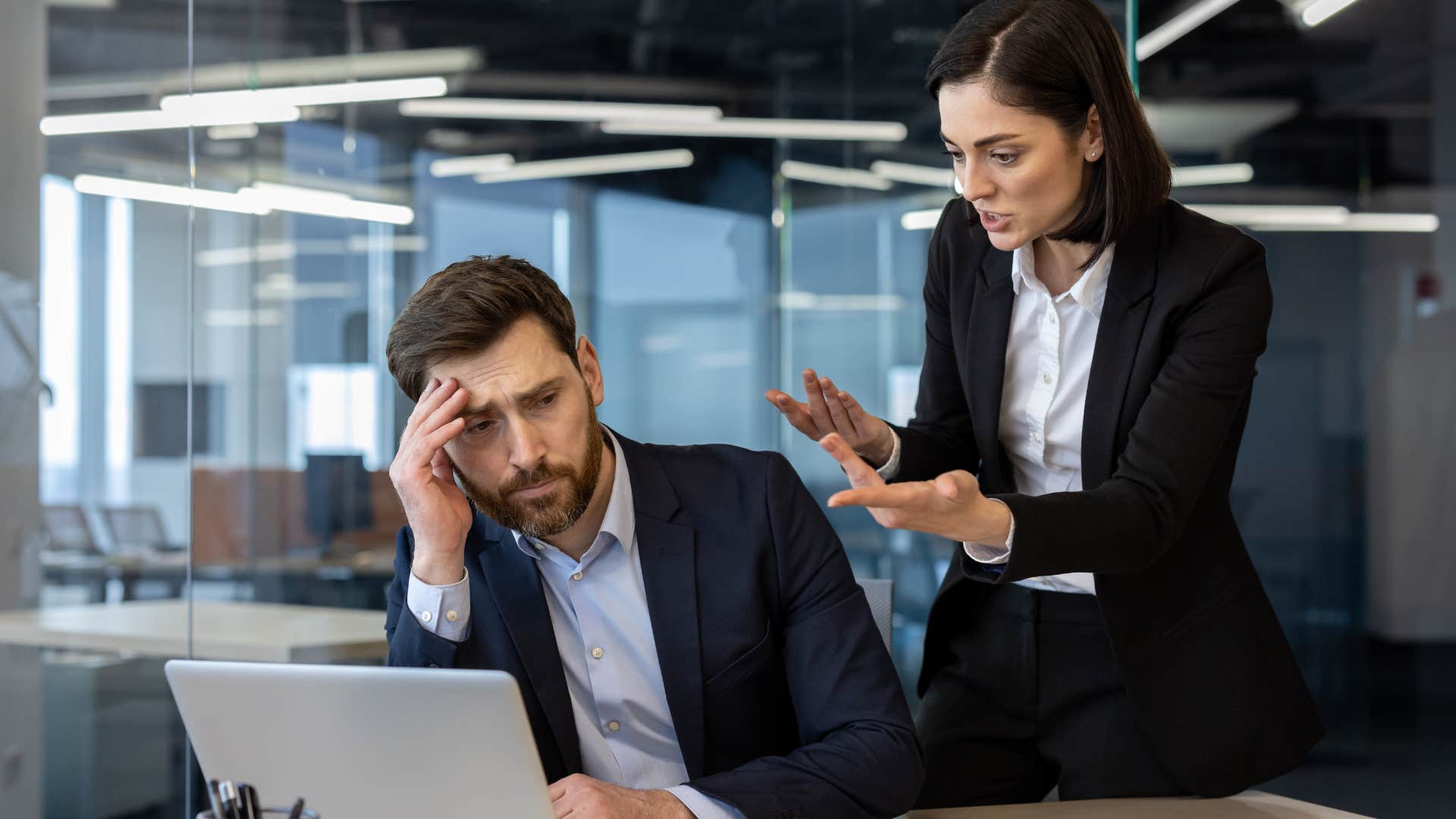 woman intimidating co-worker by arguing