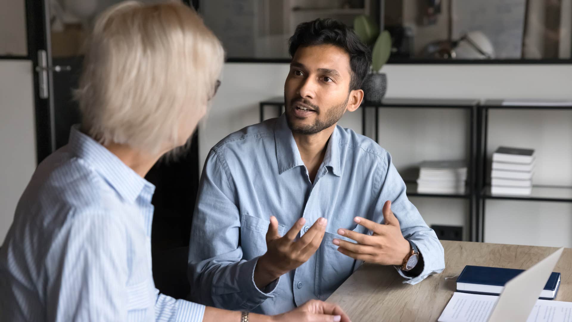 man arguing with a peer at work