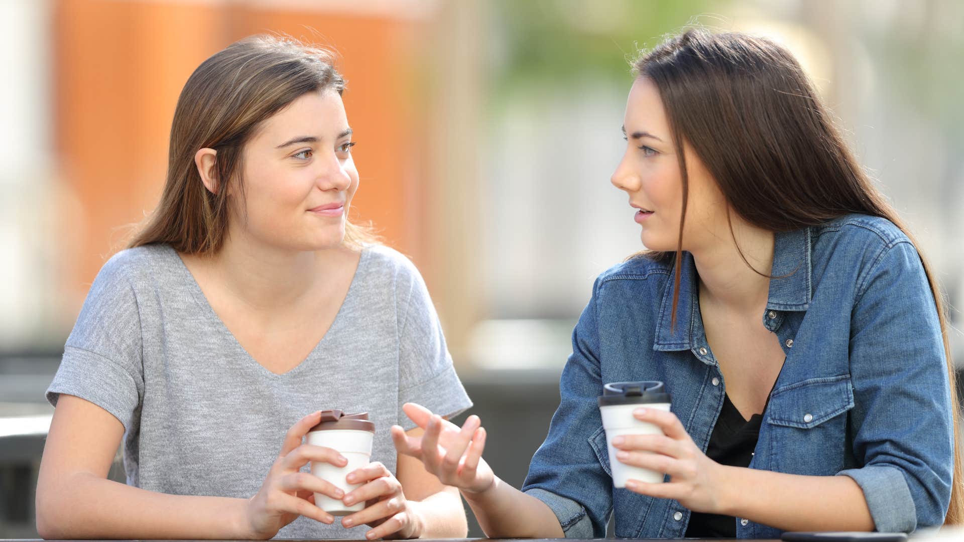 two women talking together in public