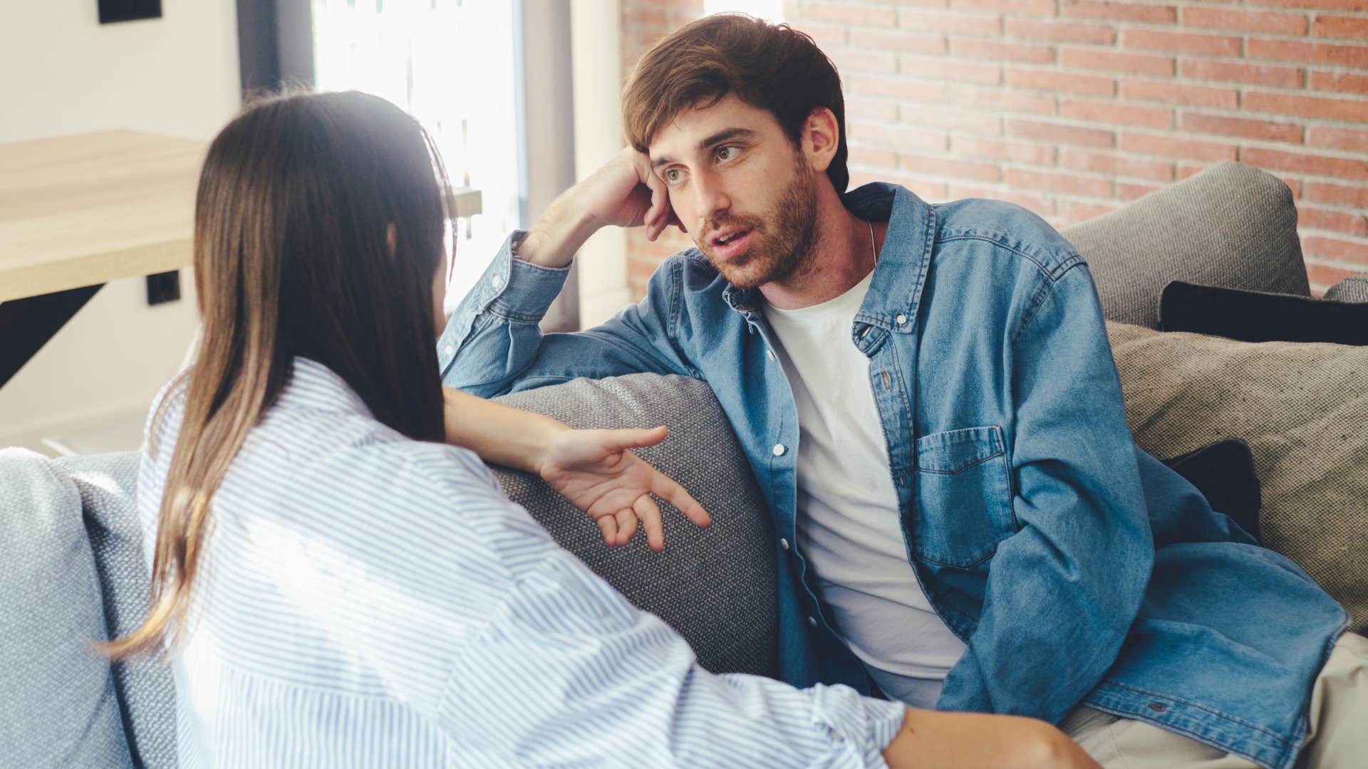 man intimidated by speaking to woman on couch